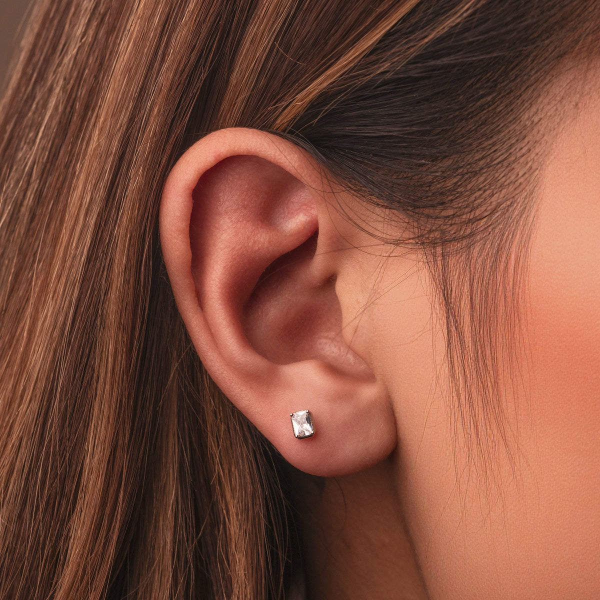 Rhodium-plated sterling silver stud earrings with emerald-cut clear cubic zirconia stones