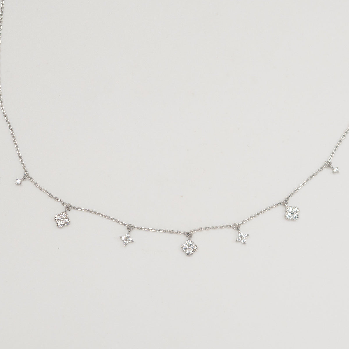 Rhodium-plated sterling silver necklace with delicate cubic zirconia flower charms