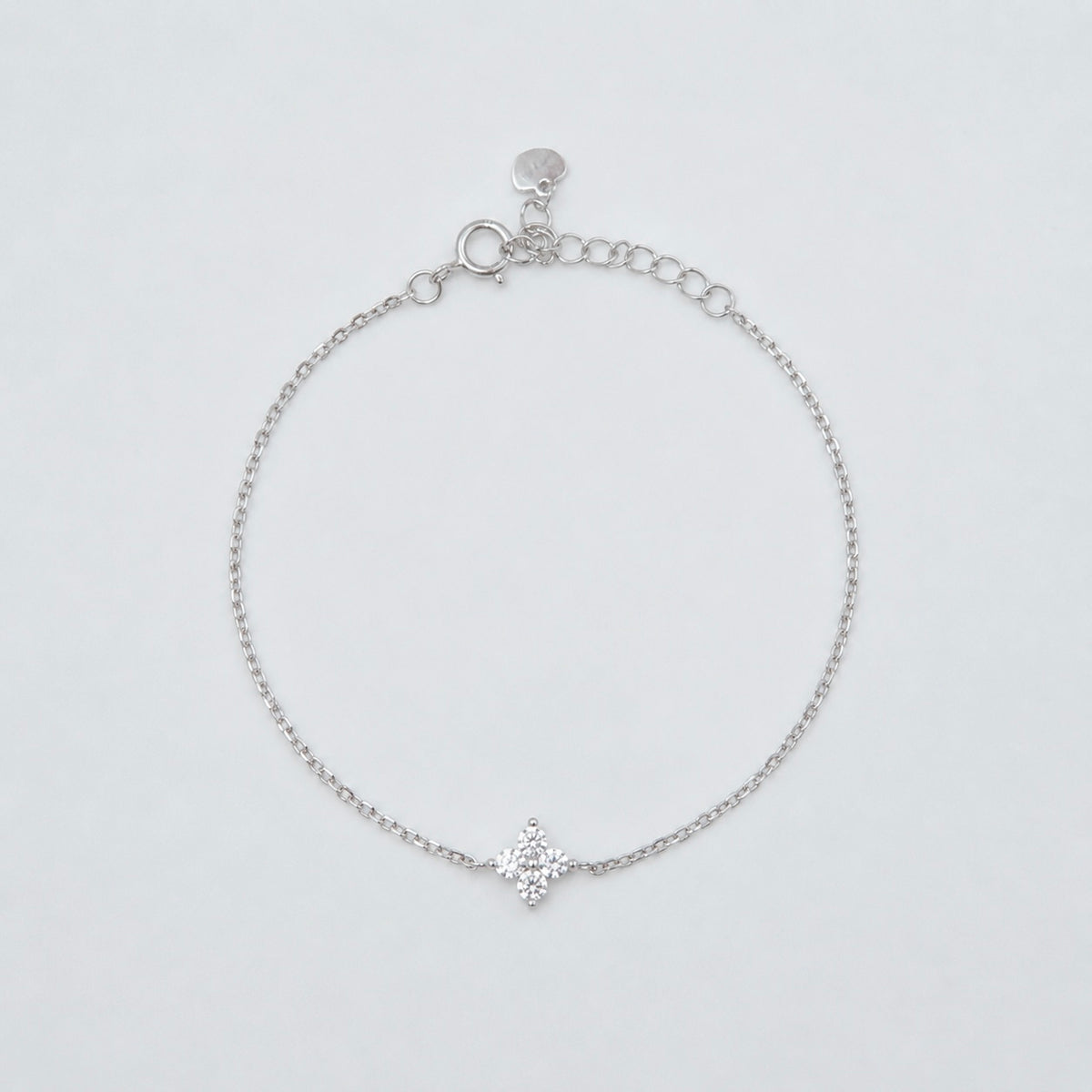 hodium-plated sterling silver bracelet with a four-petal cubic zirconia flower centerpiece
