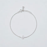 hodium-plated sterling silver bracelet with a four-petal cubic zirconia flower centerpiece