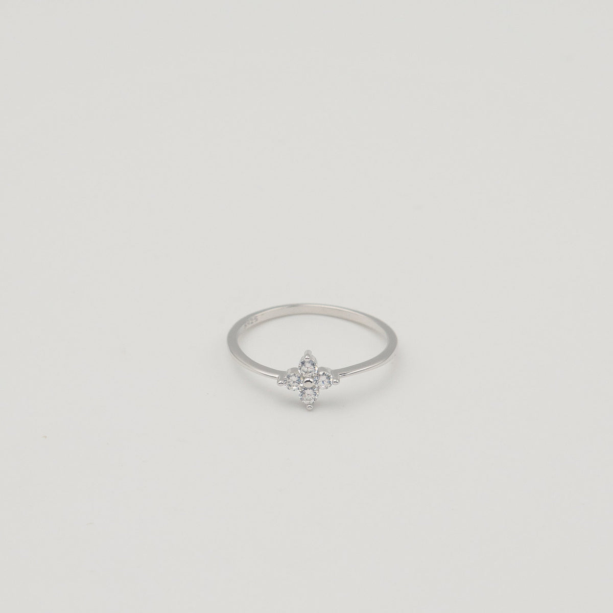 Rhodium-plated sterling silver ring with a delicate four-petal cubic zirconia flower