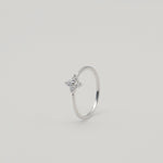 Rhodium-plated sterling silver ring with a delicate four-petal cubic zirconia flower
