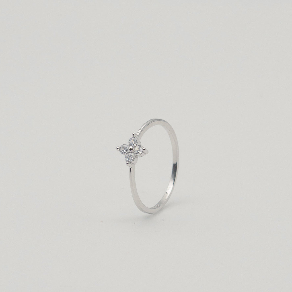 Rhodium-plated sterling silver ring with a delicate four-petal cubic zirconia flower