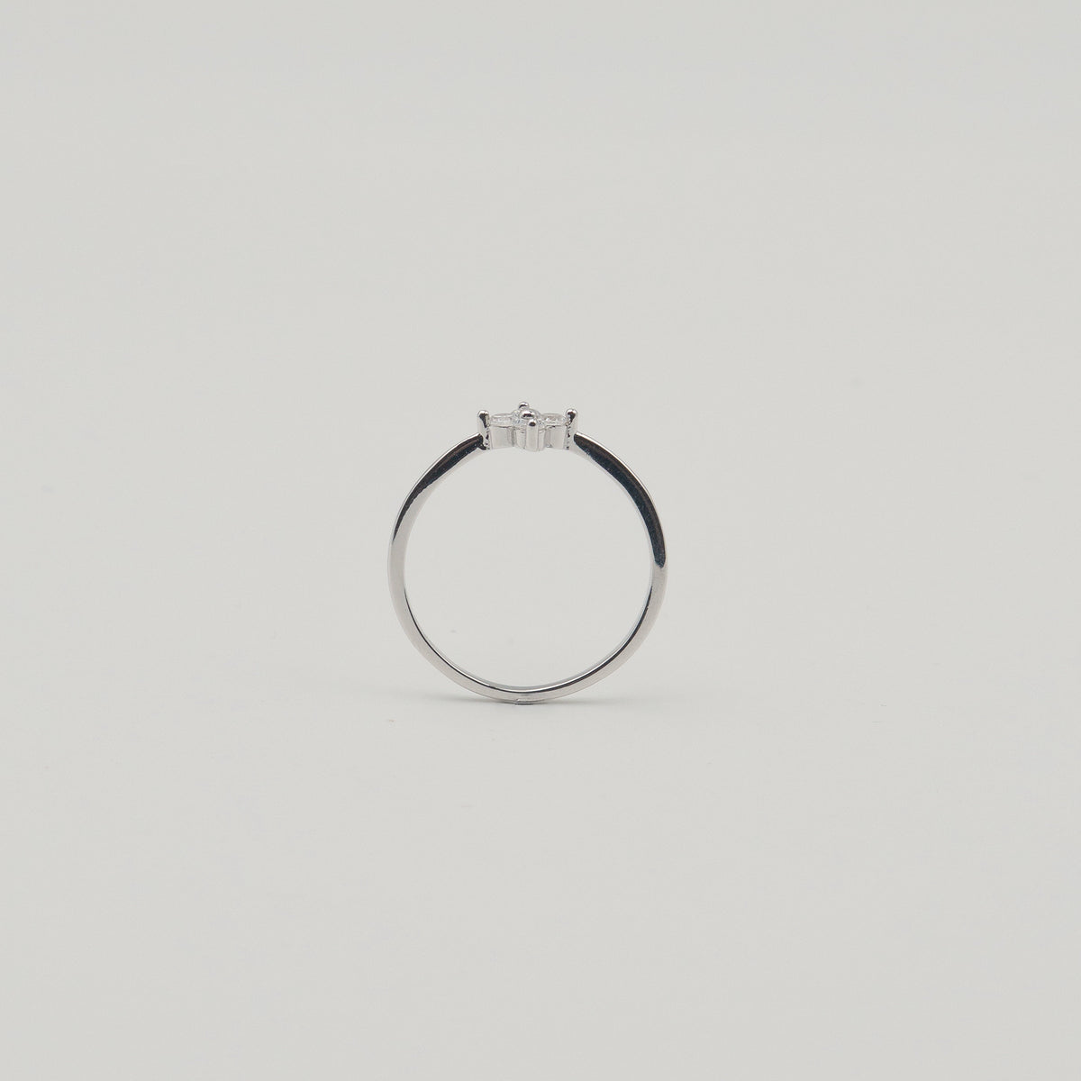 Rhodium-plated sterling silver ring with a delicate four-petal cubic zirconia flower