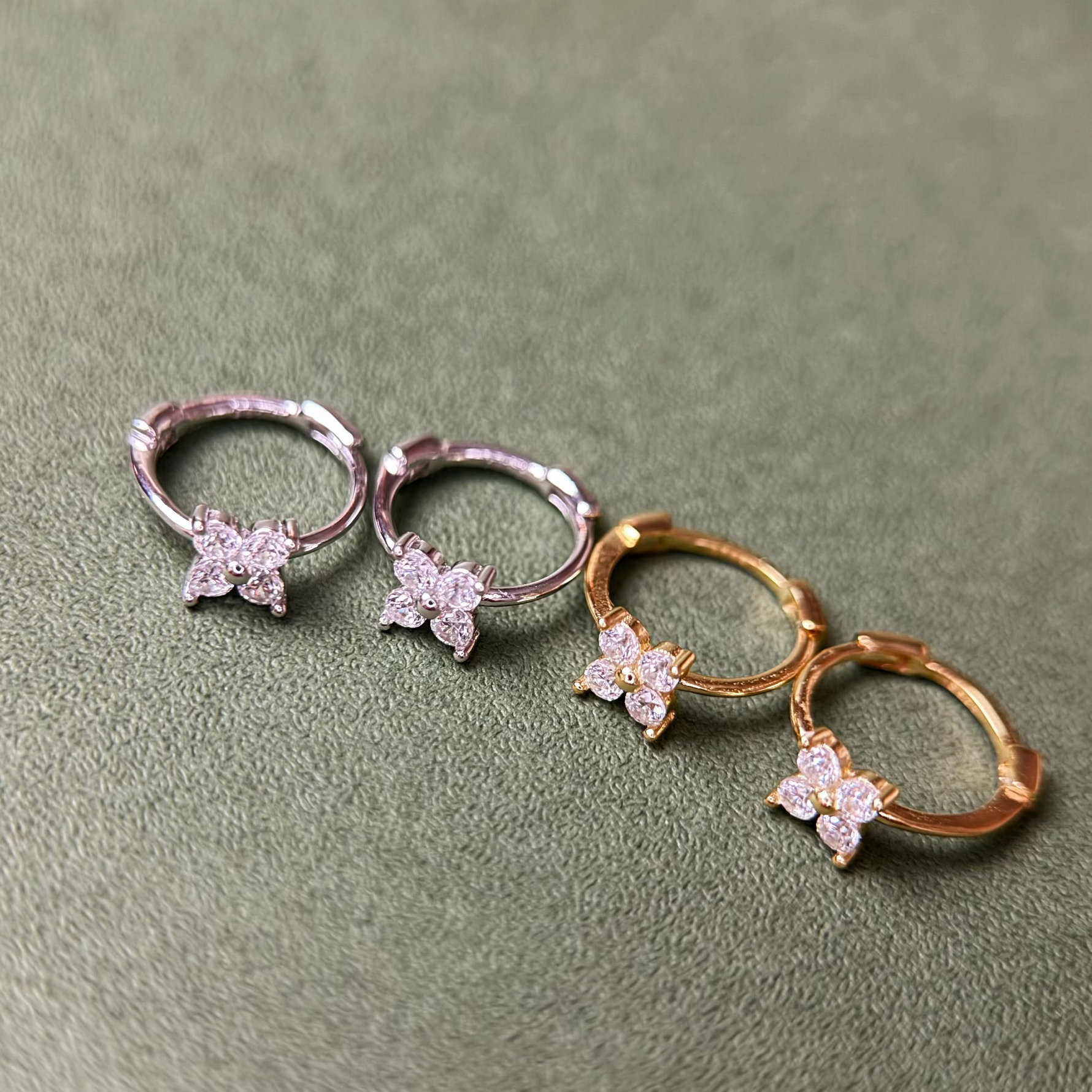 Rhodium-plated and Gold-plated sterling silver hoop earrings with four-petal cubic zirconia flower details