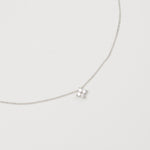 Rhodium-plated sterling silver necklace with a small four-petal cubic zirconia pendant