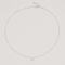 Rhodium-plated sterling silver necklace with a small four-petal cubic zirconia pendant on a light background