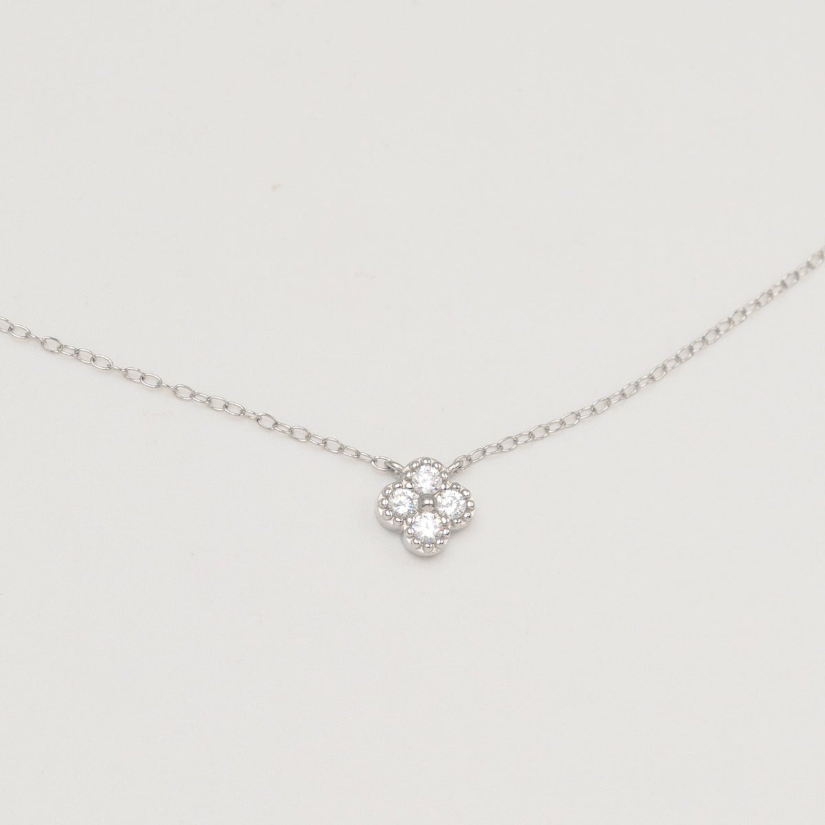 Rhodium-plated sterling silver necklace with four-petal cubic zirconia pendant 