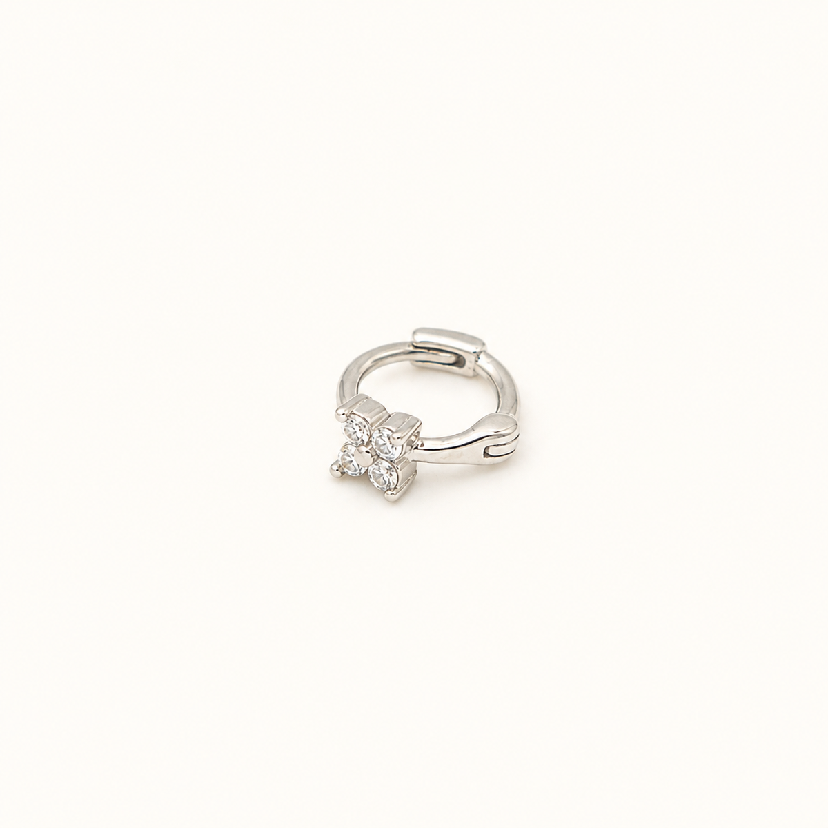 Rhodium-plated sterling silver single earring with a four-petal flower design on a white background