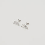 Rhodium-plated sterling silver stud earrings with marquise and round cubic zirconia leaf details on a light background