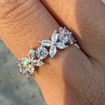 Rhodium-plated sterling silver band ring with marquise and round cubic zirconia stones worn on the finger