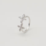 Rhodium-plated sterling silver open ring with marquise-cut clear stones arranged in floral motifs