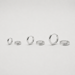 Rhodium-plated sterling silver minimalist huggie earrings with a smooth polished finish