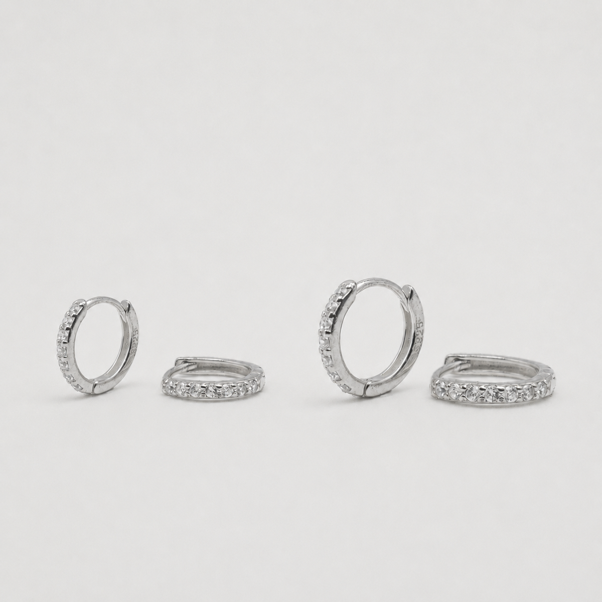Rhodium-plated sterling silver huggie earrings with clear cubic zirconia pavé stones