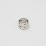 Polished silver stainless steel chunky dome ring on a white background