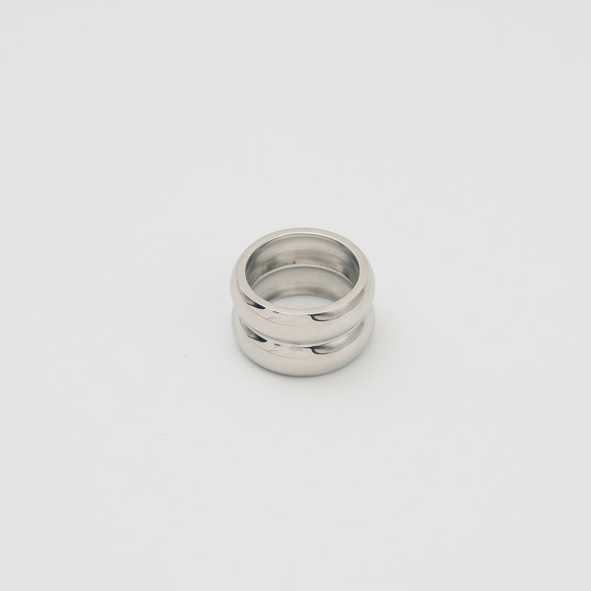 Polished silver stainless steel chunky dome ring on a white background