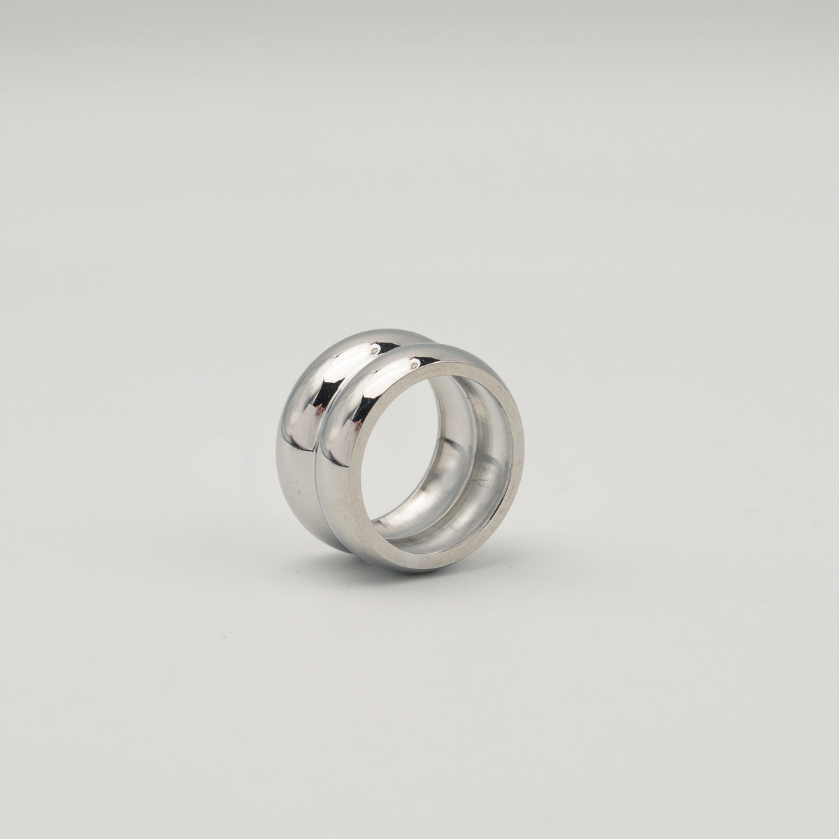 Polished silver stainless steel chunky dome ring on a white background
