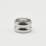 Polished silver stainless steel chunky dome ring on a white background
