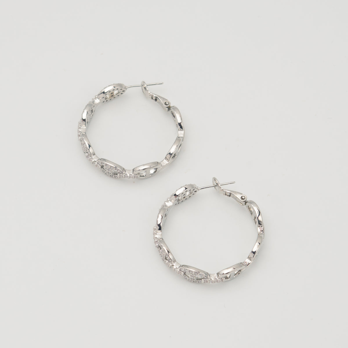 Silver stainless steel hoop earrings with pavé cubic zirconia oval link details