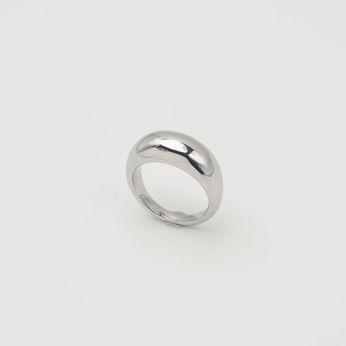 Polished silver stainless steel rounded band ring with a smooth dome profile on a light background