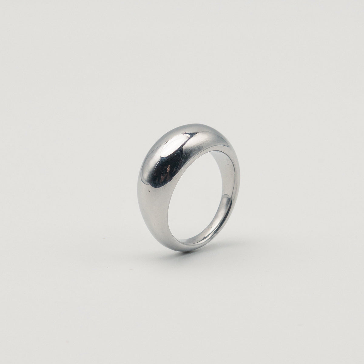Polished silver stainless steel rounded band ring with a smooth dome profile worn on finger