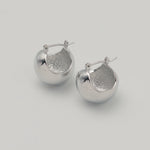 Silver stainless steel sphere drop earrings with a polished finish 