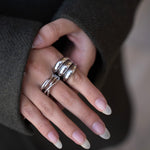 Polished silver stainless steel open ring with a chunky triple-band design worn on finger
