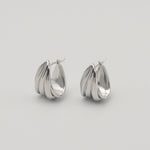 polished silver stainless steel triple hoop earrings with a sculptural layered design