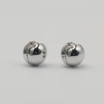 Polished sterling silver chunky clip earrings with a rounded dome shape on a light background