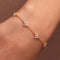 Gold-plated sterling silver flower bracelet with clear cubic zirconia stones.
