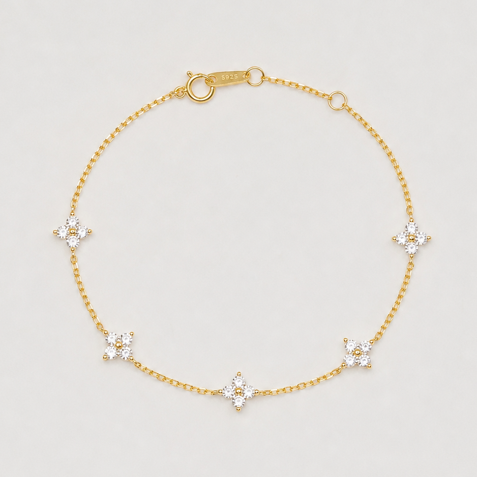 Gold-plated sterling silver flower bracelet with clear cubic zirconia stones.