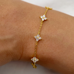 Gold-plated sterling silver flower bracelet with clear cubic zirconia stones.